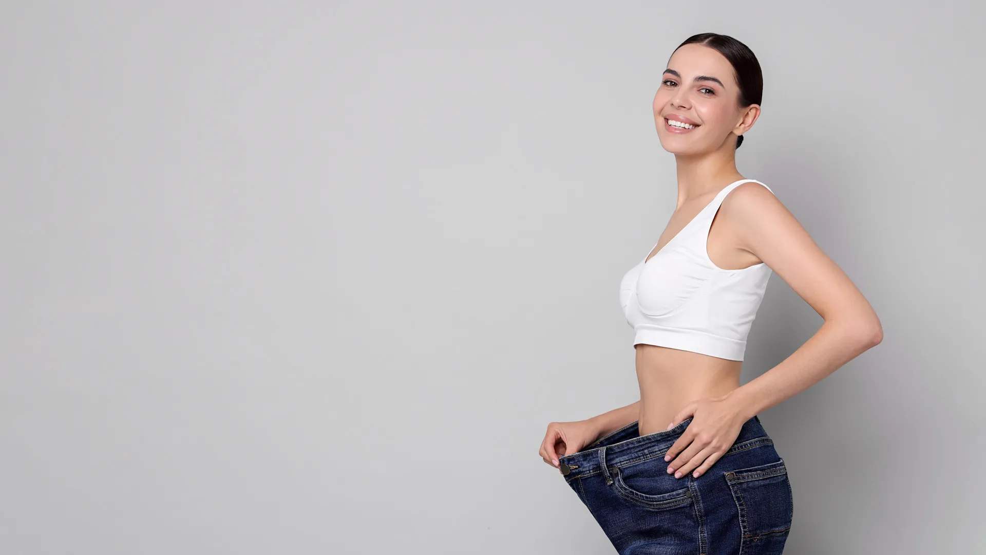 Woman celebrating weight loss results at iCRYO Clifton Park Medical Weight Loss program